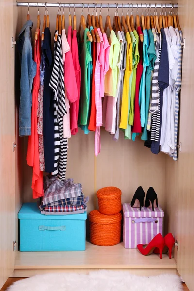 Colorful clothes in wardrobe — Stock Photo, Image