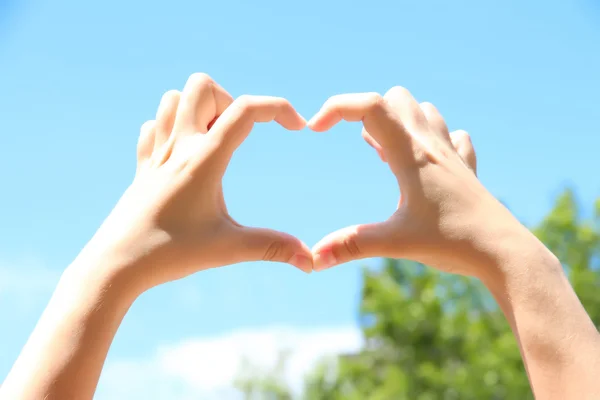 Meisje hand in hand in hart vorm — Stockfoto