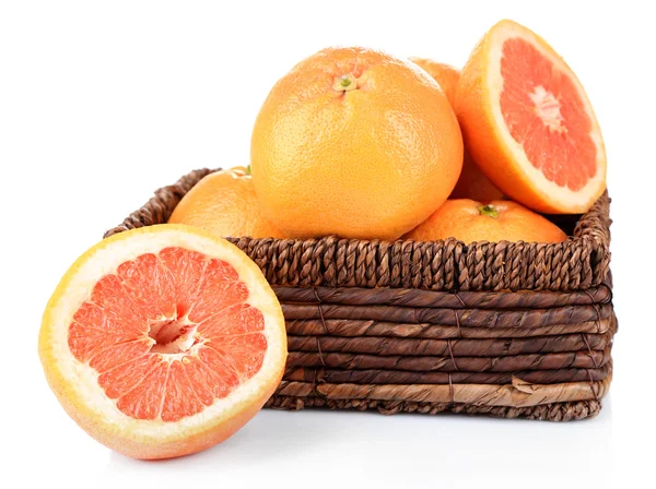 Ripe grapefruits in wicker basket — Stock Photo, Image