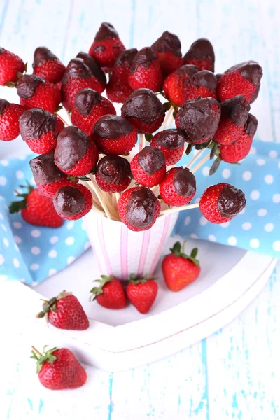 Strawberry in chocolate on skewers — Stock Photo, Image