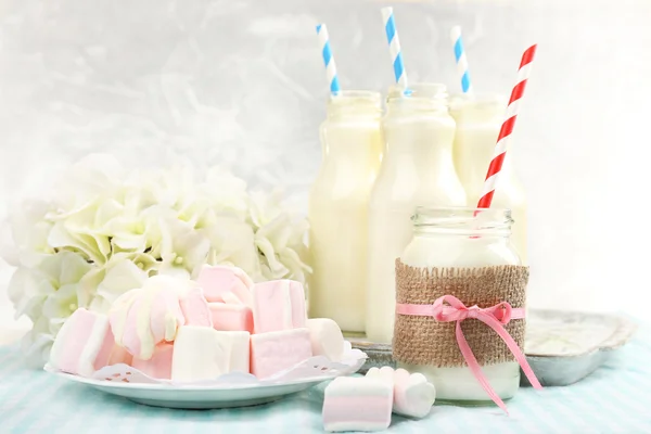 Milk in bottles with paper straws — Stock Photo, Image