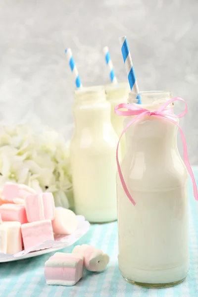 Milk in bottles with paper straws — Stock Photo, Image