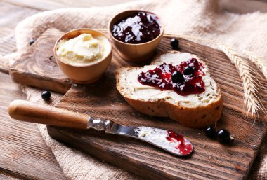 taze ekmek ile ev yapımı tereyağı ve blackcurrant jam ahşap arka plan üzerinde