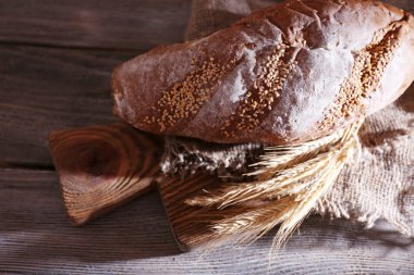 taze pişmiş ekmek ve kulak buğday, ahşap zemin üzerinde