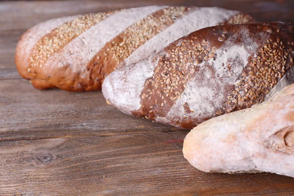 Färskt bröd på trä bakgrund — Stockfoto