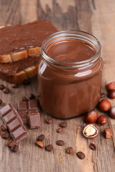 Sweet chocolate cream in jar on table close-up — Stok Foto