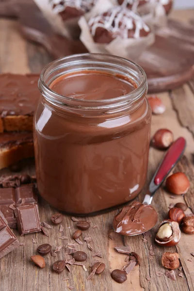 Sweet chocolate cream in jar on table close-up — Stok Foto