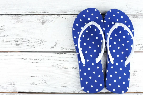 Color flip-flops on wooden background — Stock Photo, Image