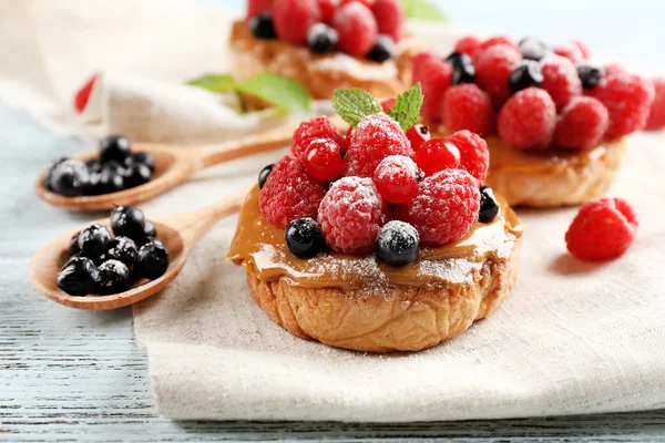 Süße Kuchen mit Beeren auf dem Tisch in Großaufnahme — Stockfoto