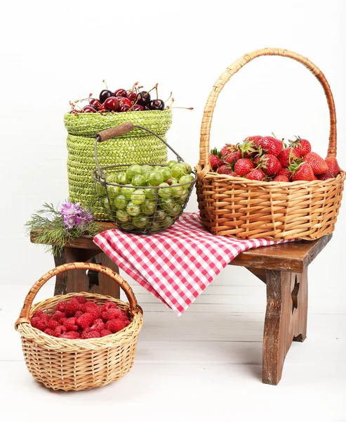 Fresh berries in baskets on white wall background — Stock Photo, Image