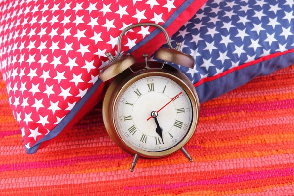 Metal clock with pillow — Stock Photo, Image