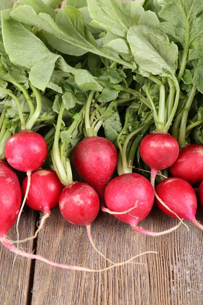 Heap of fresh radish on wooden background — Stock Photo, Image