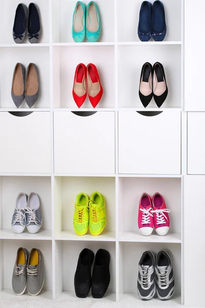 Colorful shoes on wooden shelves — Stock Photo, Image