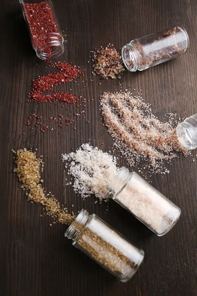 Different sea salt scattered on table, close up — Stock Photo, Image