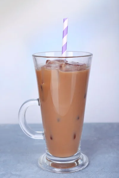 Glass of iced milk coffee on light background — Stock Photo, Image