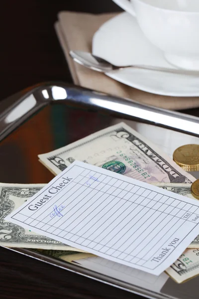 Check and money on tray — Stock Photo, Image