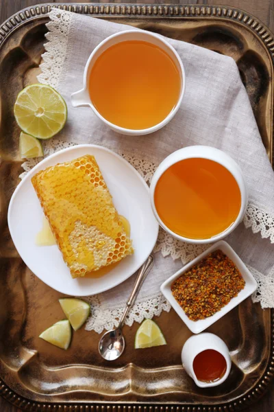 Fresh honey snack on tray on wooden table — Stock Photo, Image