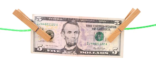 美元钞票挂在衣服管脚上的绳子上。洗钱的概念。白色背景上孤立. — 图库照片