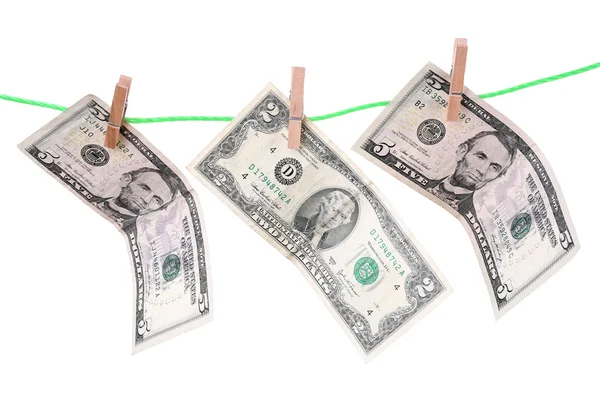 Dollar bills hanging on rope attached with clothes pins. Money-laundering concept. Isolated on white background. — Stock Photo, Image