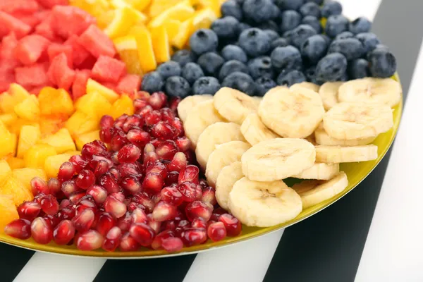 Frutas fatiadas no prato na mesa — Fotografia de Stock