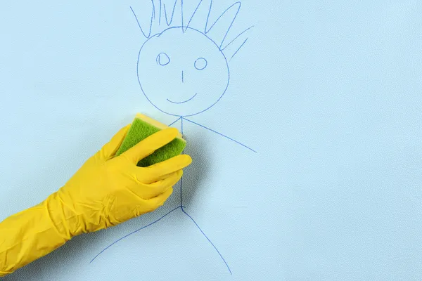 Hand in glove wiping children drawing — Stock Photo, Image