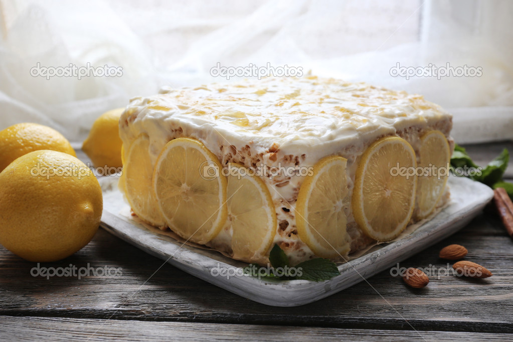 Tasty lemon cake on table at home