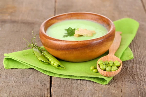 Tasty peas soup on wooden table — Stock Photo, Image