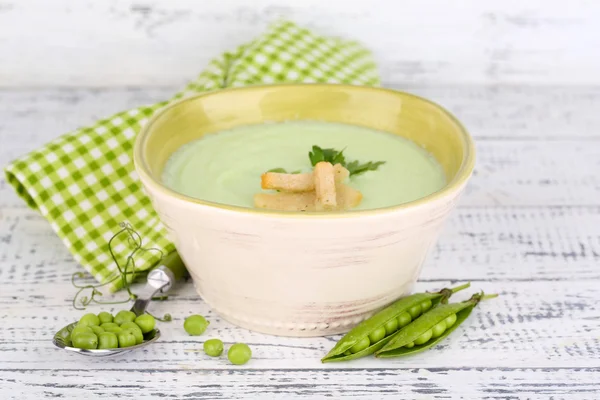 Tasty peas soup on wooden table — Stock Photo, Image