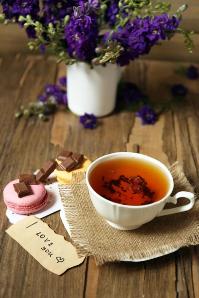 Cup of fresh herbal tea on wooden table — Stock Photo, Image