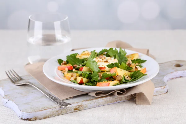 Green salad with apples, walnuts and cheese on light background — Stock Photo, Image