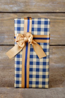 ahşap arka plan üzerinde renkli kurdele ile hediye kutusu