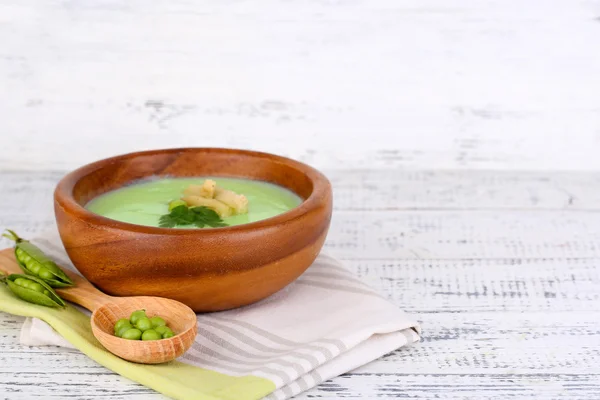 Tasty peas soup on wooden table — Stock Photo, Image