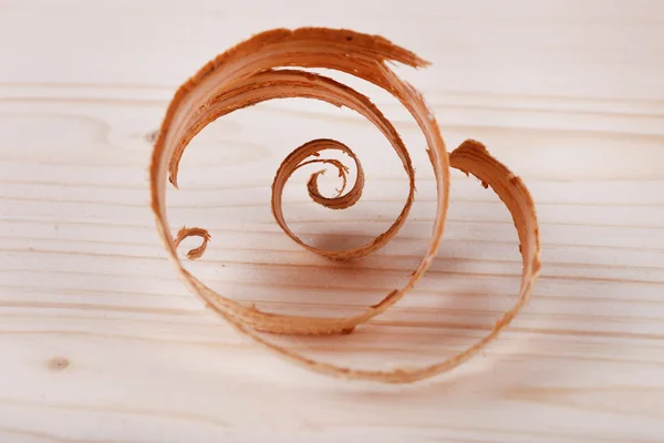 Wood shavings on wooden background closeup — Stock Photo, Image