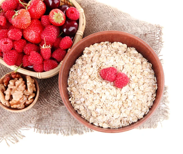 Wooden bowls of berries on sackcloth isolated on white — Stock Photo, Image