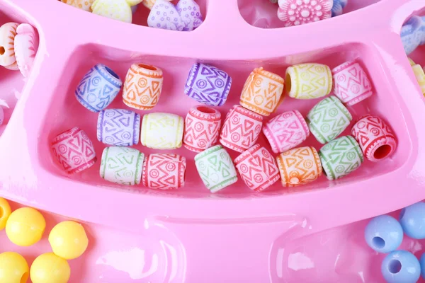 Multicoloured beading kit for children in a pink box — Stock Photo, Image