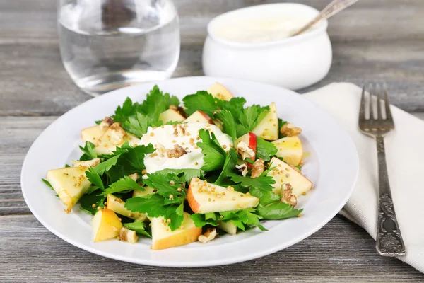 Green salad with apples, walnuts and cheese on wooden background — Stock Photo, Image