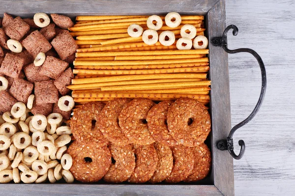 Biscuits and dry breakfast in a box on wooden background — Stock Photo, Image