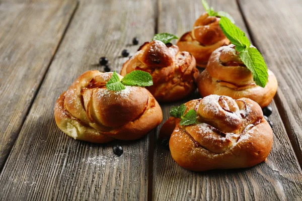 Tasty buns with berries on table close-up — Stock Photo, Image