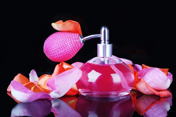 Perfume bottle with petals isolated on black — Stock Photo, Image