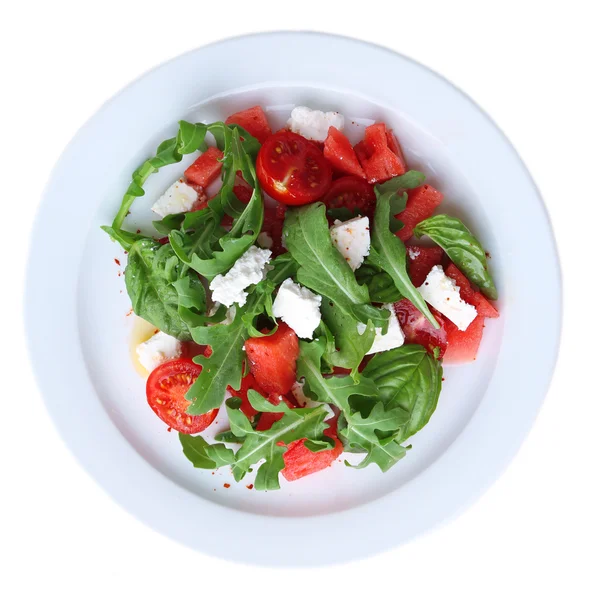 Salad with watermelon, feta, arugula and basil leaves on plate, isolated on white — Stock Photo, Image