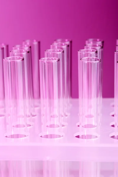 Empty test-tubes on purple background — Stock Photo, Image