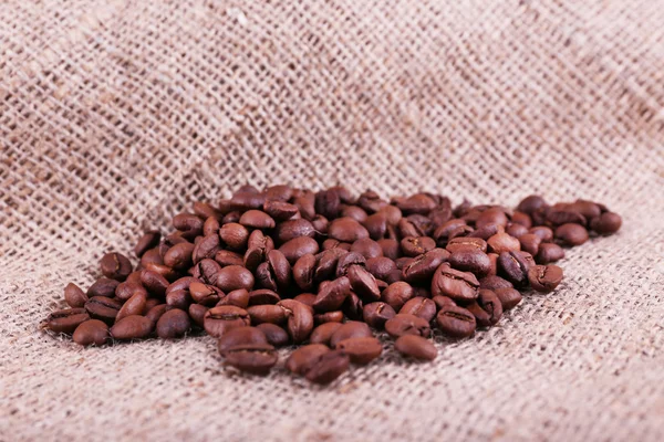 Coffee beans on sacking background closeup — Stock Photo, Image