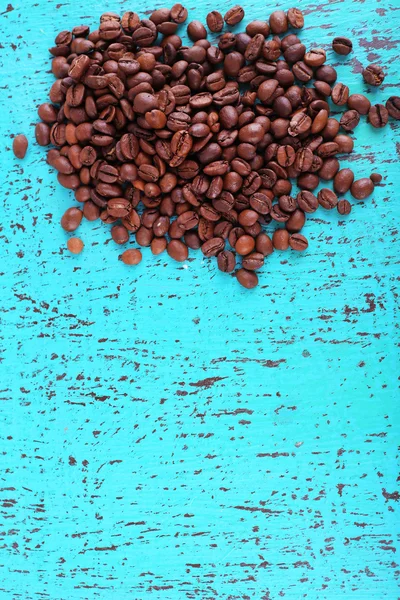 Coffee beans on blue wooden background — Stock Photo, Image