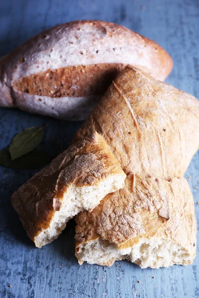 Čerstvý pečený chléb na dřevěném pozadí — Stock fotografie