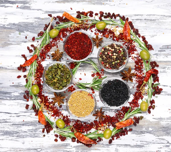 Spices with herbs and dried chilly pepper on wooden background — Stock Photo, Image