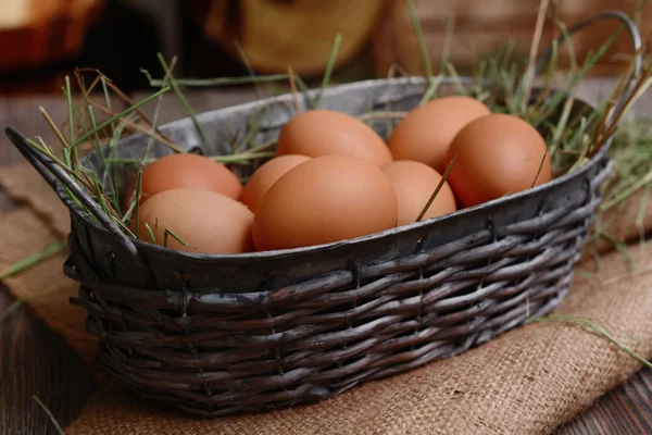 Huevos en canasta de mimbre en primer plano de la mesa —  Fotos de Stock