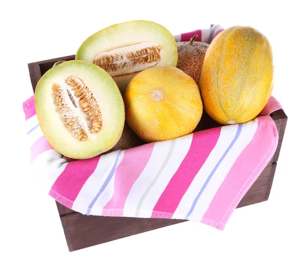 Melons in wooden box on napkin isolated on white — Stock Photo, Image