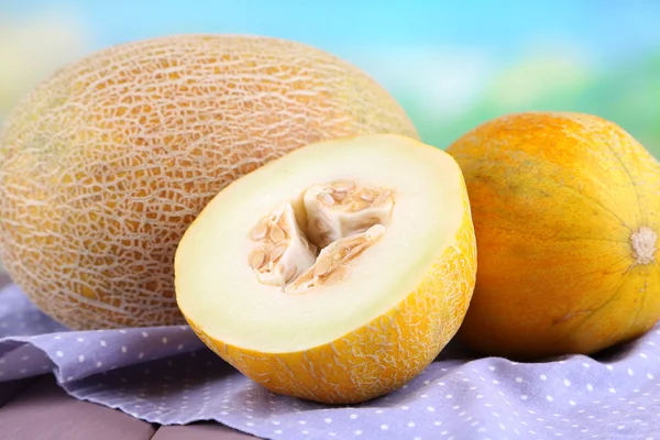 Melon on napkin on wooden table on natural background — Stock Photo, Image