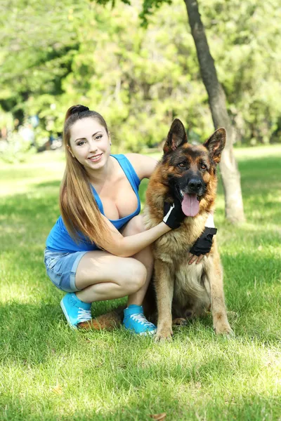 Красивая девушка с собакой в парке — стоковое фото