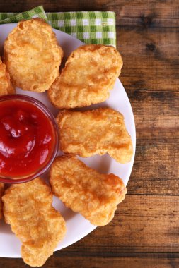 Chicken nuggets with sauce on table close-up clipart